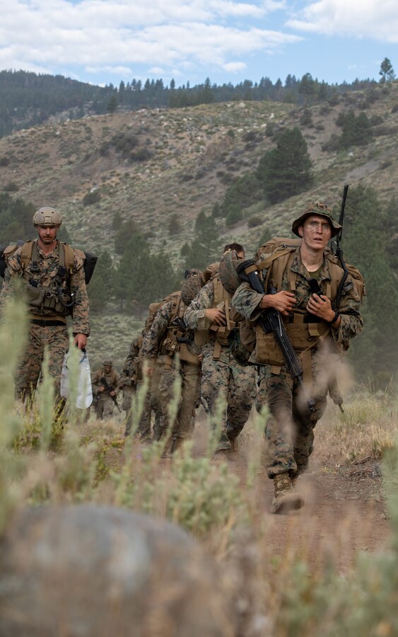 U.S. Marines with 1st Battalion, 24th Marine Regiment, 4th Marine Division, Marine Forces Reserve, hike back after finishing the final exercise for Mountain Training Exercise 4-22 at Marine Corps Mountain Warfare Training Center, Bridgeport, Calif., July 28, 2022. MTX 4-22 allowed reserve Marines to participate in mountain warfare operations for realistic combat training to facilitate increased readiness for the Marine Forces Reserve. (U.S. Marine Corps photo by Cpl. Jonathan L. Gonzalez)