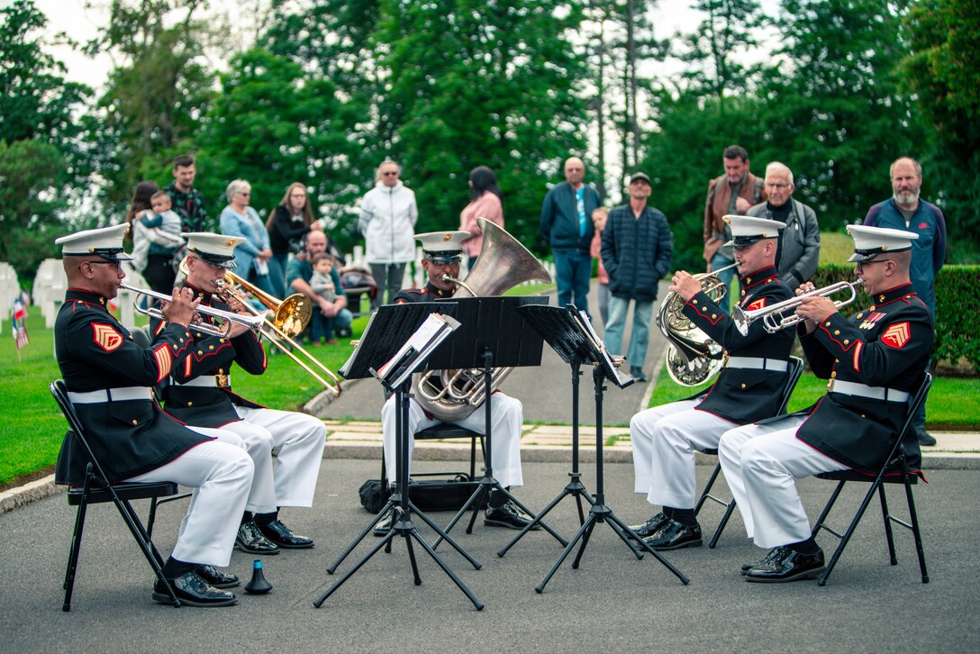 U.S. Marines from the 2d Marine Division Band perform at a ceremony at Oise-Aisne American Cemetery marking the 104th anniversary of the Battle of Belleau Wood, May 29, 2022. The Battle of Belleau Wood is remembered for the intensity of the fighting and sustained, as well as for the participation of the 5th and 6th Marine Regiments. To this day, Marines assigned to these two regiments wear the French fourragere on the left shoulder of their uniforms as a reminder of their unit's distinguished service during the First World War.