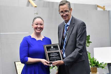 IMAGE: : Emily Johnson (pictured left), F/A-18 Human Factors Lead from Naval Air Weapons Station China Lake, was awarded the 2022 Naval Laboratory and Centers Coordinating Group G. Dennis White Early Career Human Systems Integration Practitioner Award from Dr. Brett Seidle (pictured right), SES, Deputy Assistant Secretary of the Navy Research, Development, Test, and Engineering.