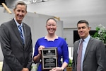 IMAGE: Emily Johnson, F/A-18 Human Factors Lead from Naval Air Weapons Station China Lake, was awarded the 2022 Naval Laboratory and Centers Coordinating Group G. Dennis White Early Career Human Systems Integration Practitioner Award. Pictured from left to right: Dr. Brett Seidle, SES, Deputy Assistant Secretary of the Navy Research, Development, Test, and Engineering, Johnson and Dale Sisson, SES, Naval Surface Warfare Center Dahlgren Division Technical Director.