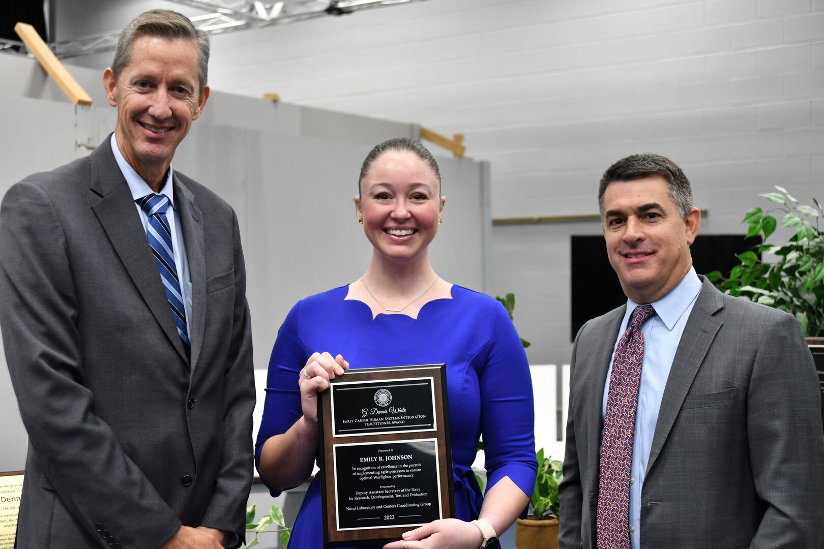 IMAGE: Emily Johnson, F/A-18 Human Factors Lead from Naval Air Weapons Station China Lake, was awarded the 2022 Naval Laboratory and Centers Coordinating Group G. Dennis White Early Career Human Systems Integration Practitioner Award. Pictured from left to right: Dr. Brett Seidle, SES, Deputy Assistant Secretary of the Navy Research, Development, Test, and Engineering, Johnson and Dale Sisson, SES, Naval Surface Warfare Center Dahlgren Division Technical Director.