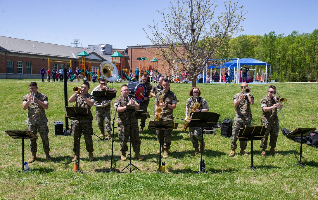 U.S. Marines with the Quantico Marine Corps Band perform during the signing of the Adopt A School proclamation at Quantico Middle High School on Marine Corps Base Quantico, Virginia, April 28, 2022. The signing of the proclamation showcases the mutually agreed upon partnership between the MCBQ's DoDEA schools and military commands.
