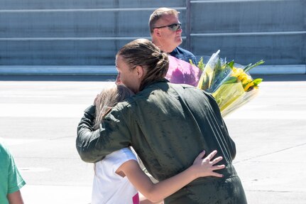 Servicewoman hugs her child