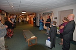 A group of people gather in a hallway.