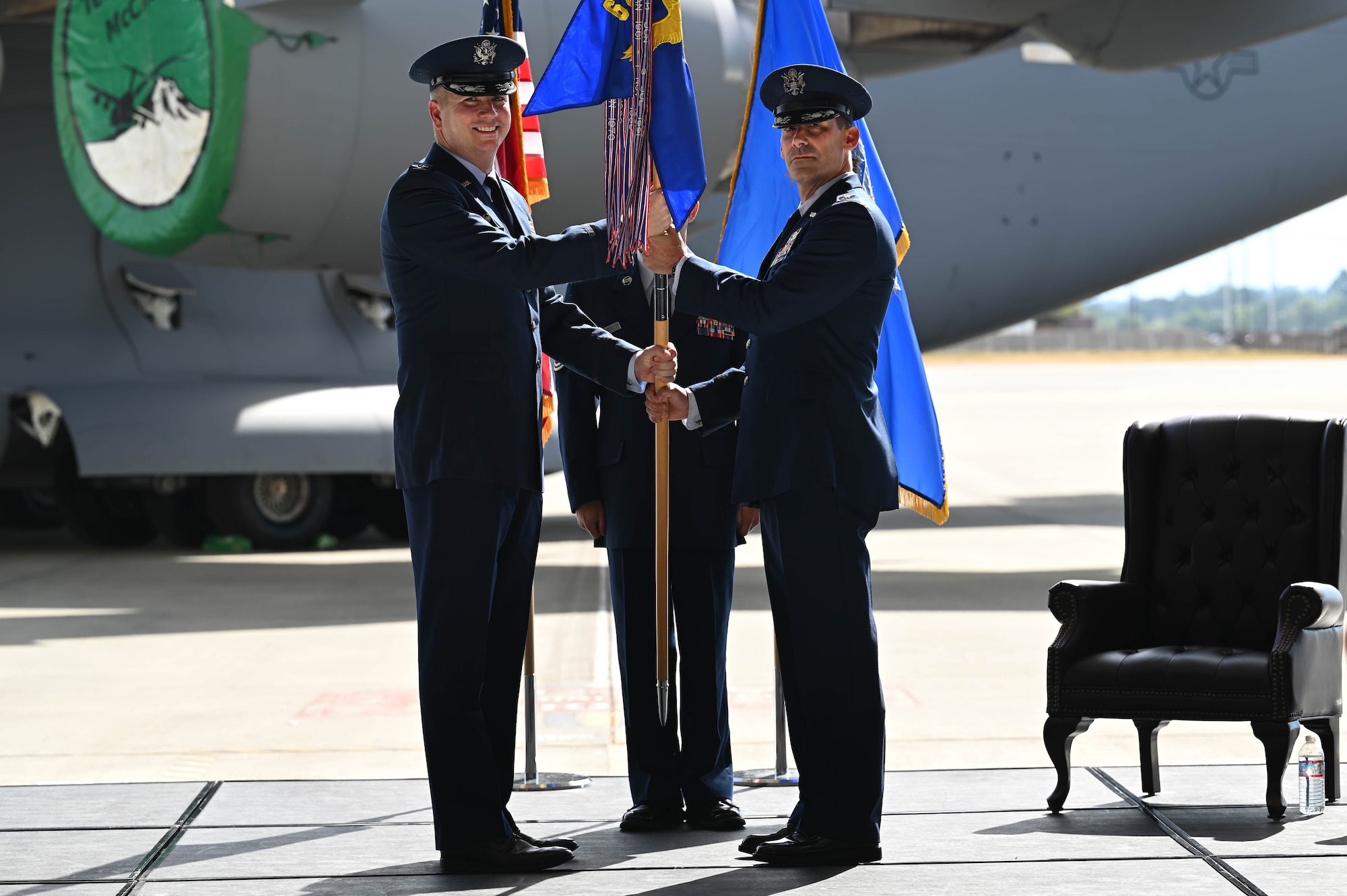 U.S. Air Force Col. Christopher Joyce, right, incoming commander of the 62d Maintenance Group receives guidon from U.S. Air Force Col. David Fazenbaker, commander of the 62d Airlift Wing during 62d MXG assumption of command ceremony at Joint Base Lewis-McChord, Washington, Aug. 5, 2022. Joyce formerly worked as the director of the Strategic Solutions Division at the Defense Logistics Agency Operations Directorate J3. (U.S. Air Force photo by Airman 1st Colleen Anthony)