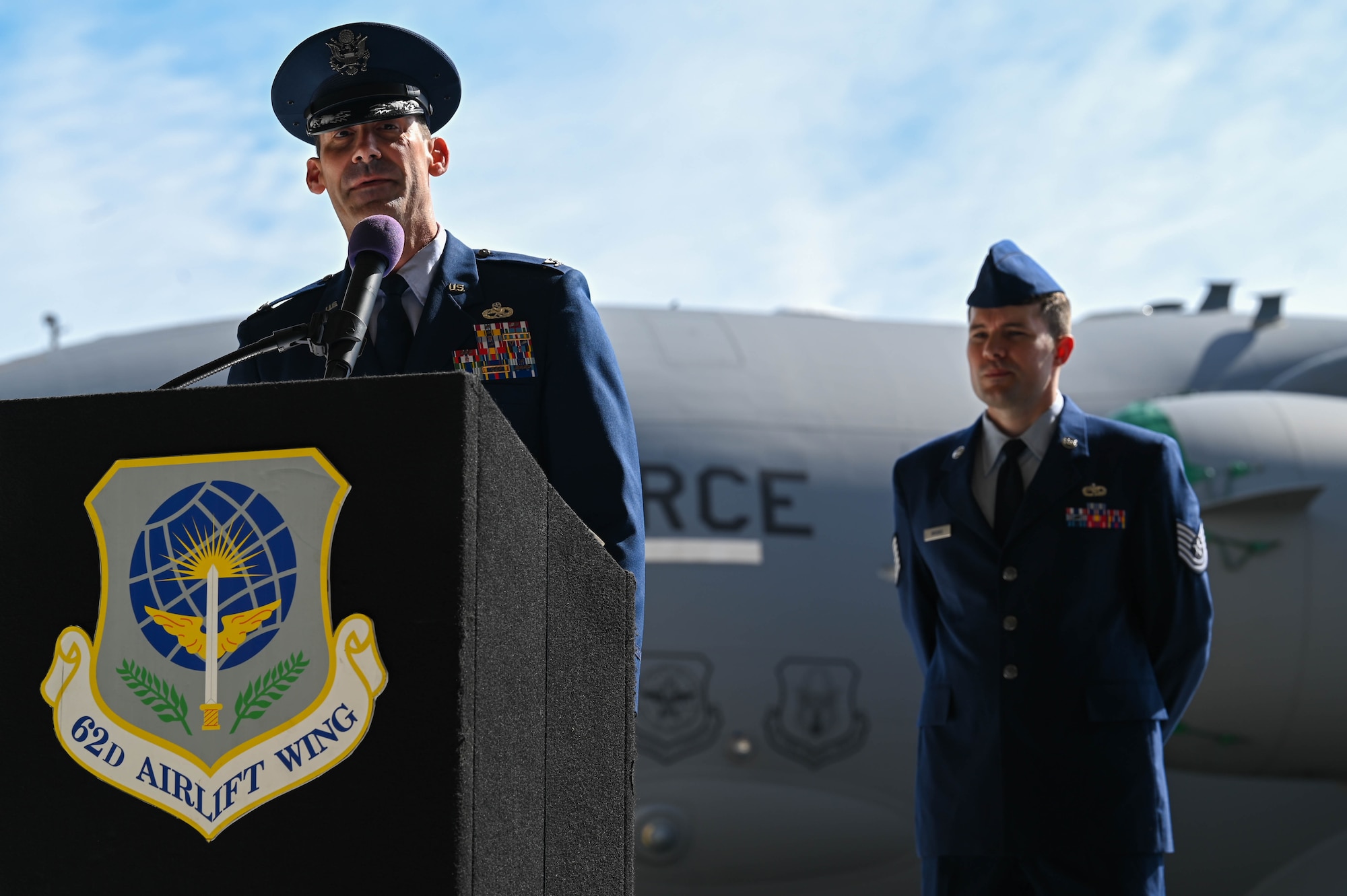 U.S. Air Force Col. Christopher Joyce, speaks during his assumption of command ceremony for the 62d Maintenance Group, at Joint Base Lewis-McChord, Washington, Aug. 5, 2022. The 62d MXG maintains, services and loads 48 assigned C-17 Globemaster III aircraft worth over $10 billion, in support of worldwide combat and humanitarian airlift and airdrop operations. (U.S. Air Force photo by Airman 1st Colleen Anthony)