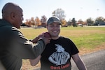 Blake Conley works with a coach while learning shot put.