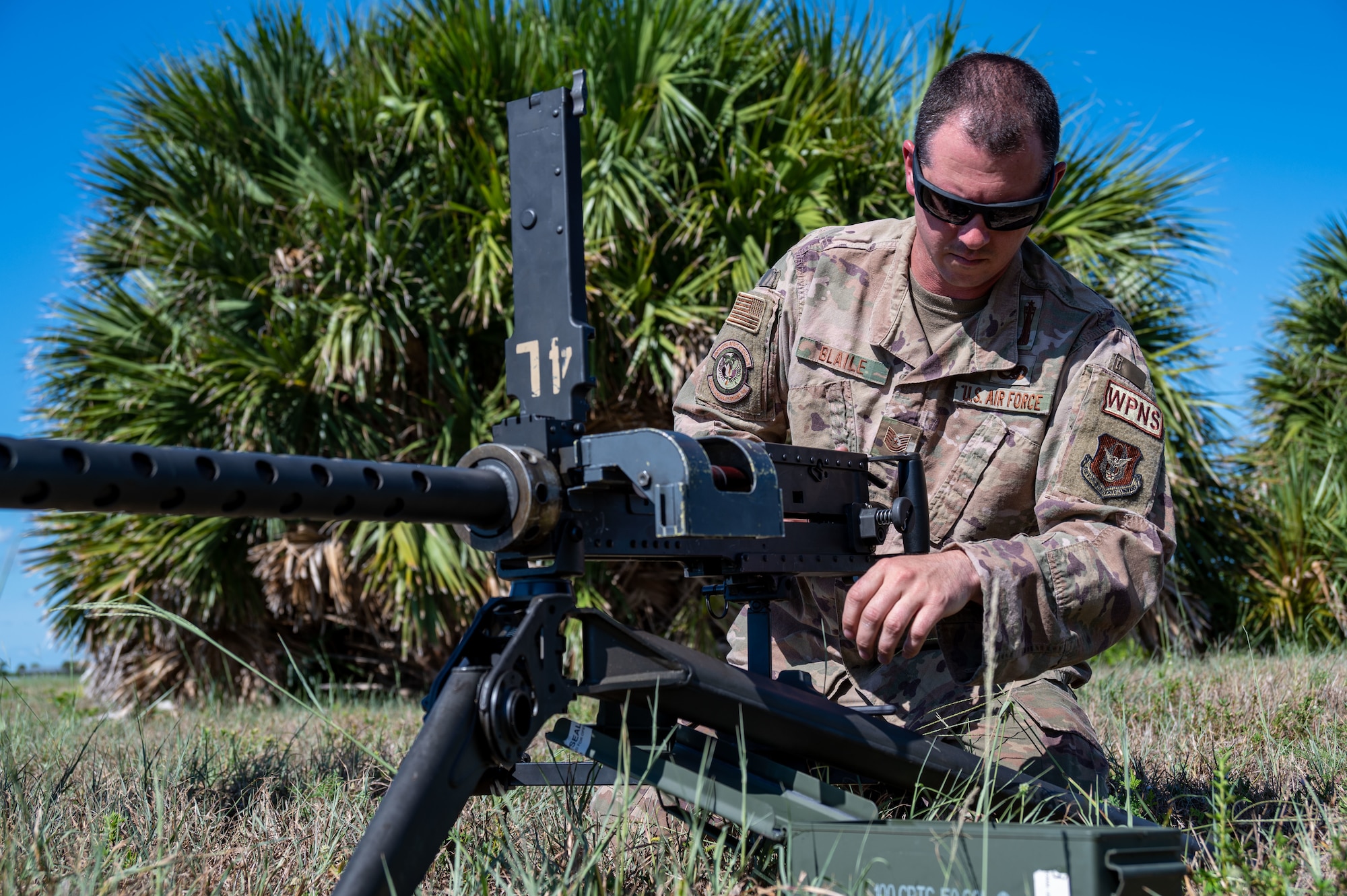 Technical Sgt. Tony Blaile, 920th Aircraft Maintenance Squadron weapons expeditor, checks to ensure a GAU-18 machine gun is properly set onto a lightweight tripod mount Aug. 6, 2022 at Patrick Space Force Base, Florida. (U.S. Air Force photo by Master Sgt. Kelly Goonan)