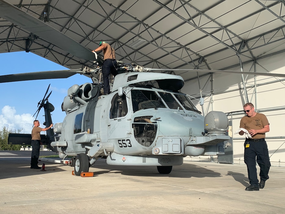 Sailors cleaning a helicopter