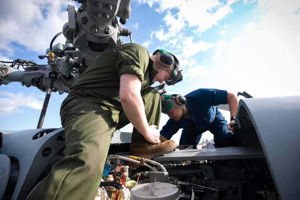Sailors working on a helicopter
