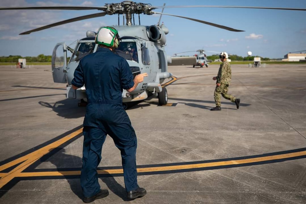 Sailors next to a helicopter