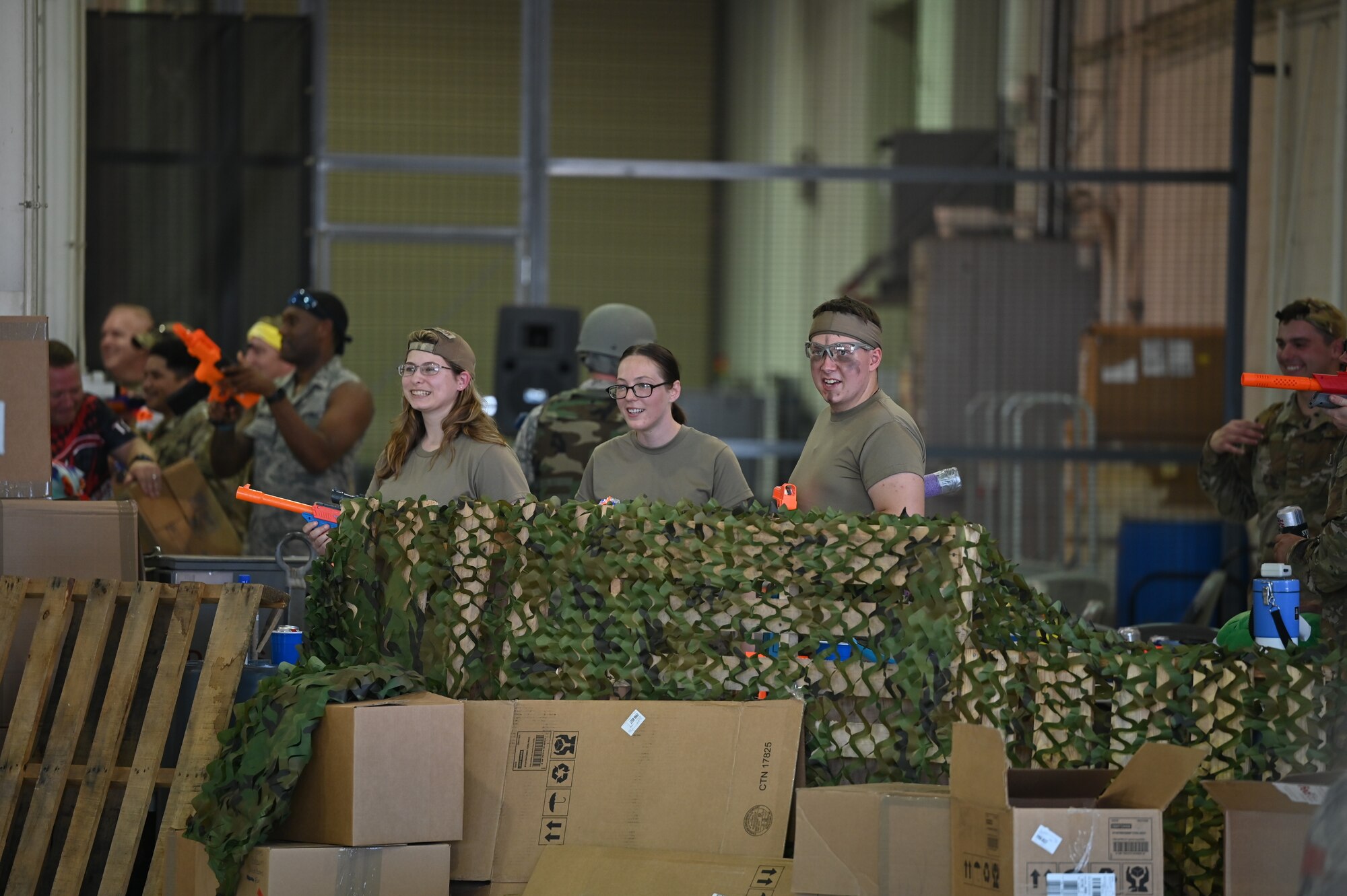 Team Dover Airmen safeguard their group’s fortified base during the Combat Dining-In on Dover Air Force Base, Delaware, Aug. 5, 2022. Airmen represented their respective group in a series of challenges that included tug-of-war and Nerf gun battles. The gathering gave commanders and their Airmen a chance to interact in an unofficial capacity. (U.S. Air Force photo by Staff Sgt. Marco A. Gomez)