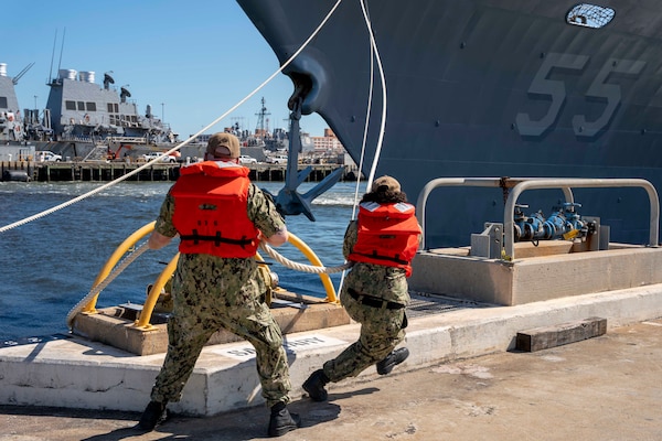 Line handlers, assigned to the aircraft carrier USS Gerald R. Ford (CVN 78), cast off mooring lines from the pier as the Ticonderoga-class guided-missile cruiser USS Leyte Gulf (CG 55) gets underway aboard Naval Station Norfolk, Aug. 8. Leyte Gulf, assigned to the George H.W. Bush Carrier Strike Group, departed Naval Station Norfolk on a scheduled deployment in support of naval operations to maintain maritime stability and security in order to ensure access, deter aggression and defend U.S., allied and partner interests.