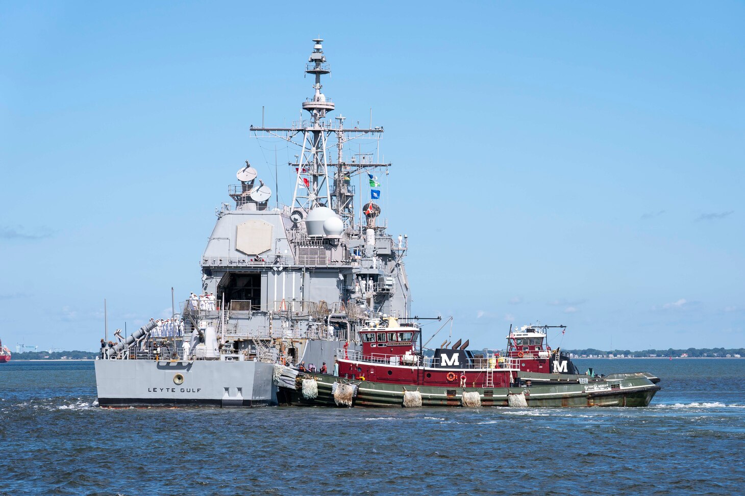 Sailors man the rails as the Ticonderoga-class guided-missile cruiser USS Leyte Gulf (CG 55) departs Naval Station Norfolk, Aug. 8. Leyte Gulf, assigned to the George H.W. Bush Carrier Strike Group, departed Naval Station Norfolk on a scheduled deployment in support of naval operations to maintain maritime stability and security in order to ensure access, deter aggression and defend U.S., allied and partner interests.