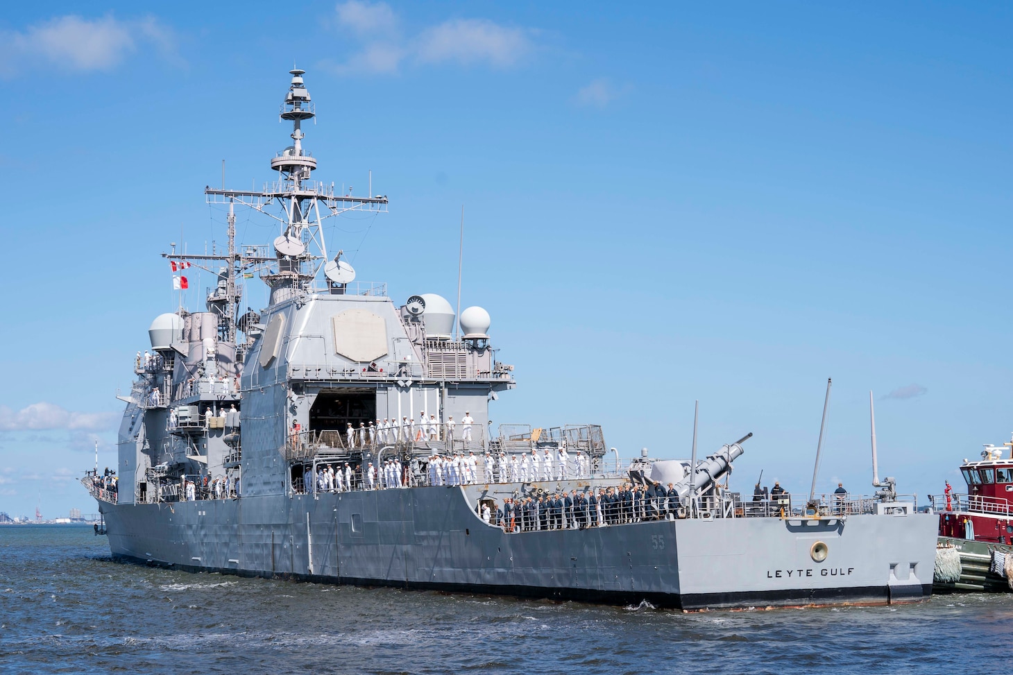 Sailors man the rails as the Ticonderoga-class guided-missile cruiser USS Leyte Gulf (CG 55) departs Naval Station Norfolk.