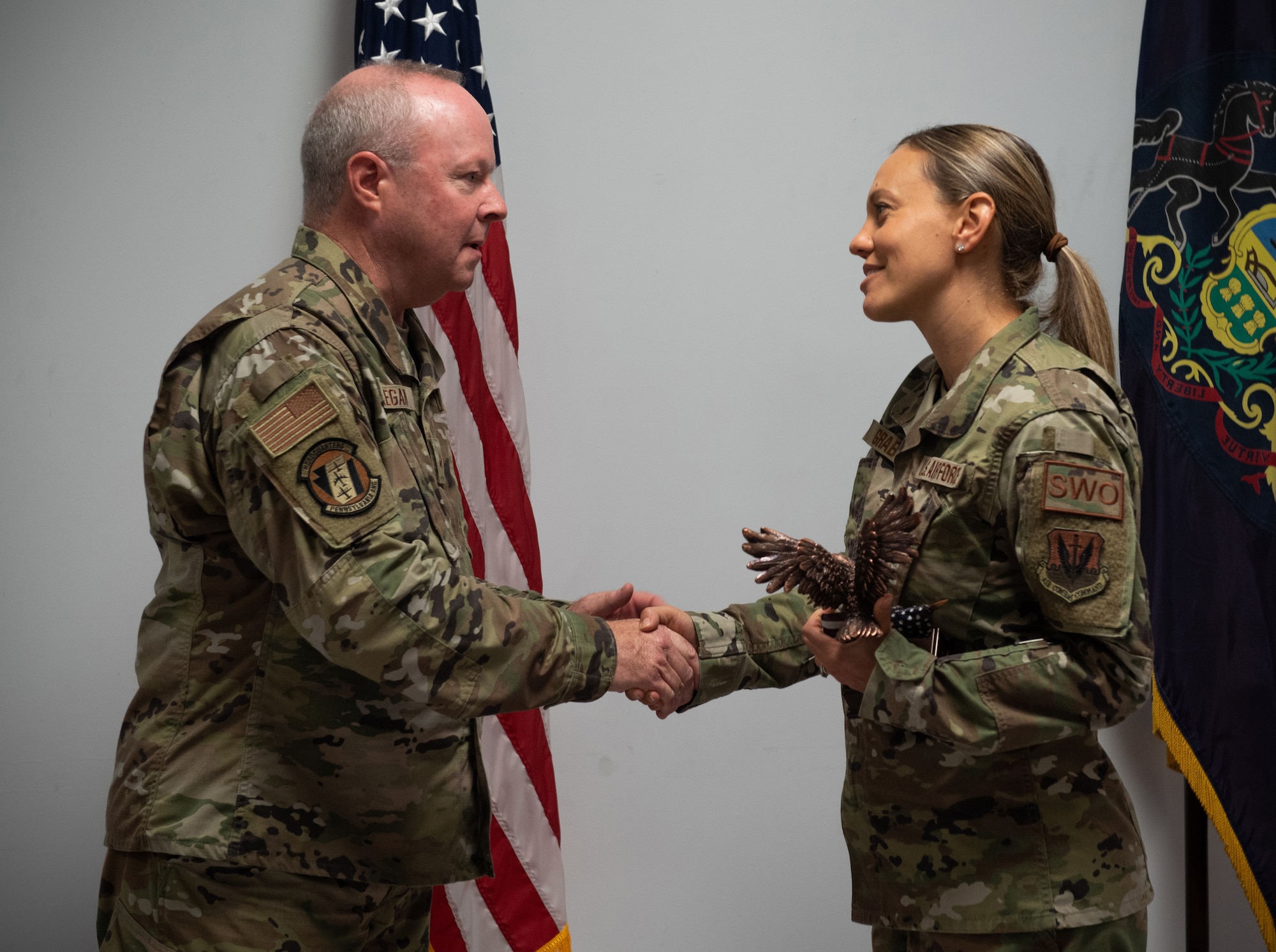 U.S. Air Force Brig. Gen. Michael Regan Jr. presents Senior Master Sgt. Kristin Graby with the Outstanding Airman of the Year Award at the 193rd Special Operations Wing (SOW) August 6, 2022, in Middletown, Pennsylvania.