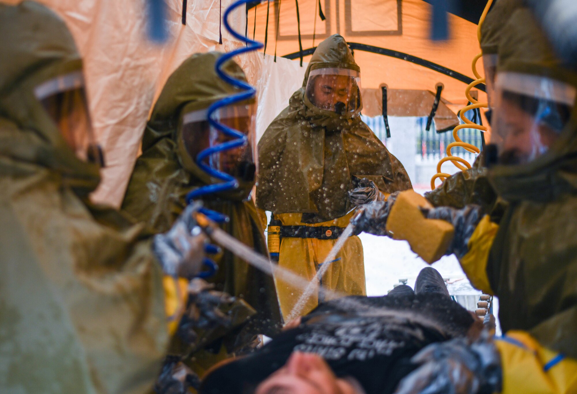 The 61st Medical Squadron begin the decon process with a patient.