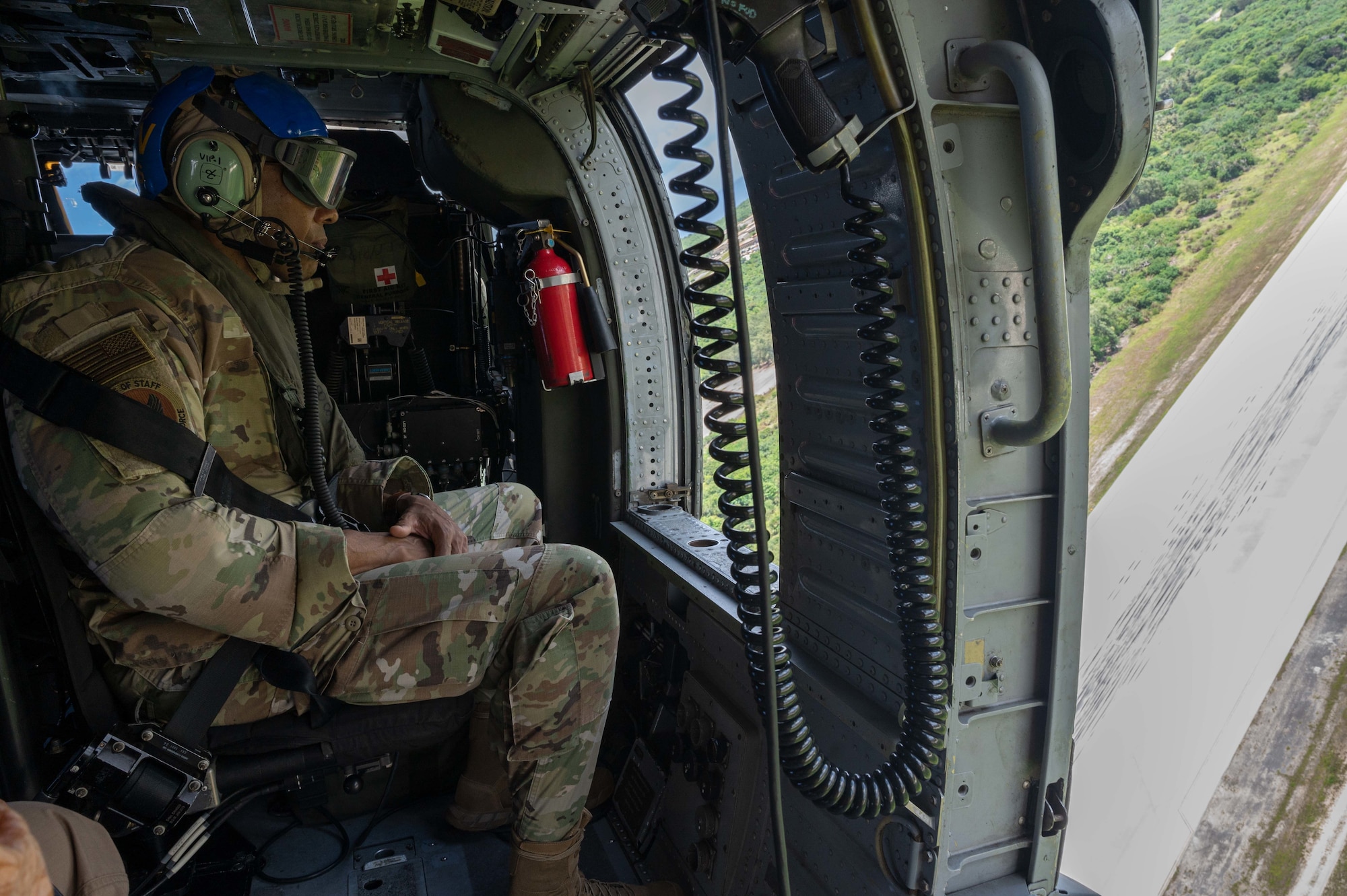 U.S. Air Force Chief of Staff Gen. CQ Brown, Jr. flies over the flightline with U.S. Navy Helicopter Sea Combat Squadron 25 at Northwest Field, Guam, Aug. 7, 2022.