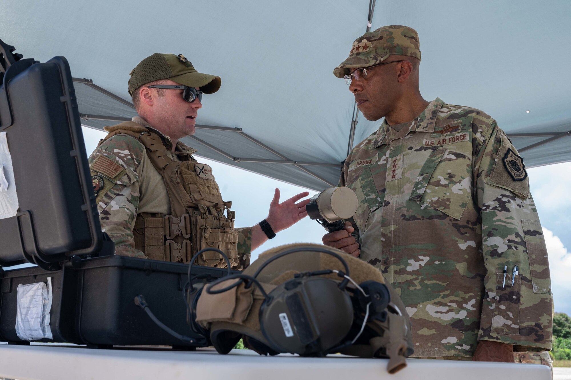 U.S. Air Force Chief of Staff Gen. CQ Brown, Jr. is briefed by U.S. Air Force Maj. John Newman, 736th Security Forces Squadron Commander, about the capabilities Air Force personnel in Guam bring to the Indo-Pacific region at Northwest Field, Guam, Aug. 7, 2022.