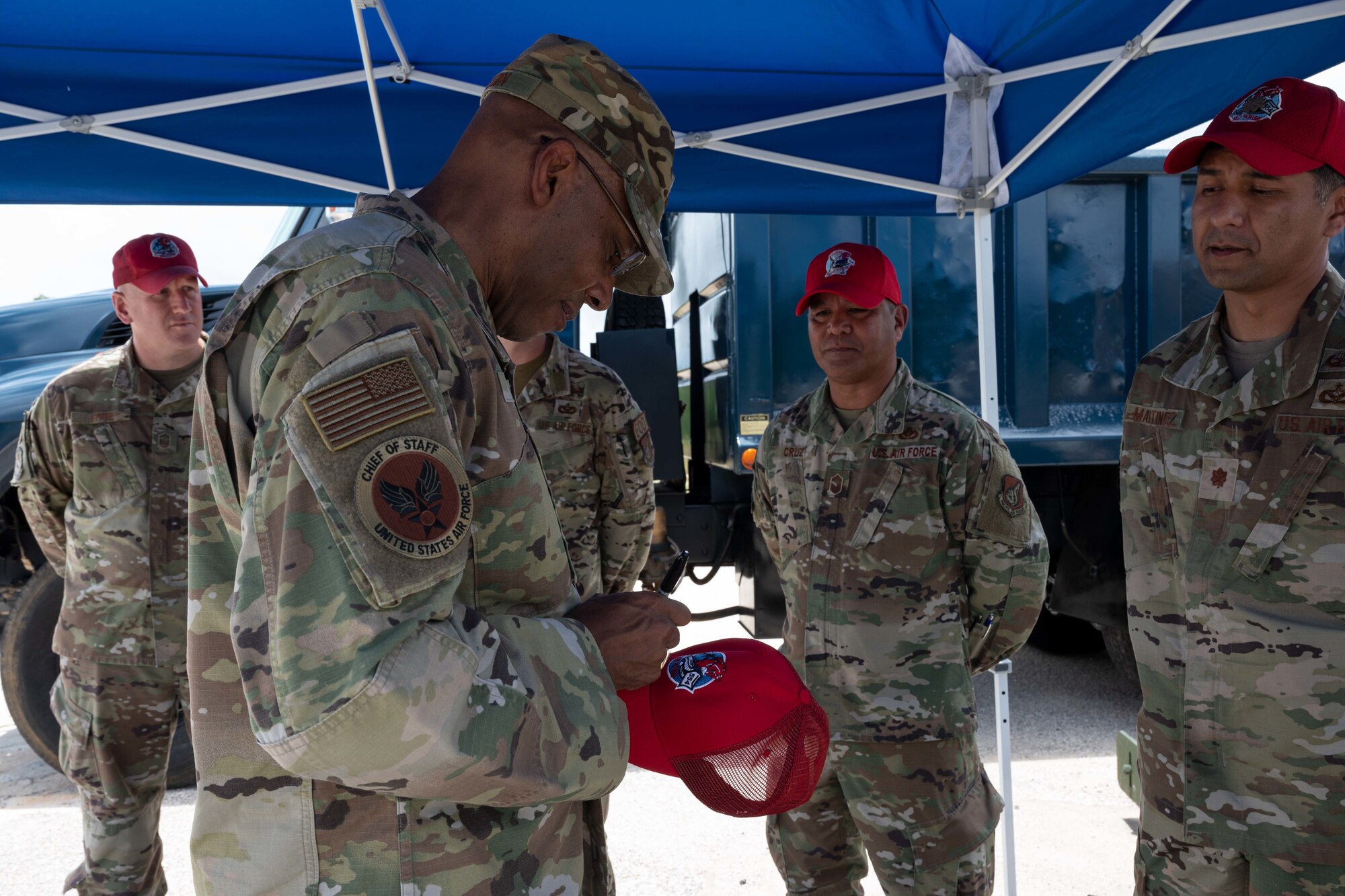 U.S. Air Force Chief of Staff Gen. CQ Brown, Jr. signs a hat for the 554 REDHORSE leadership at Northwest Field, Guam, Aug. 7, 2022.