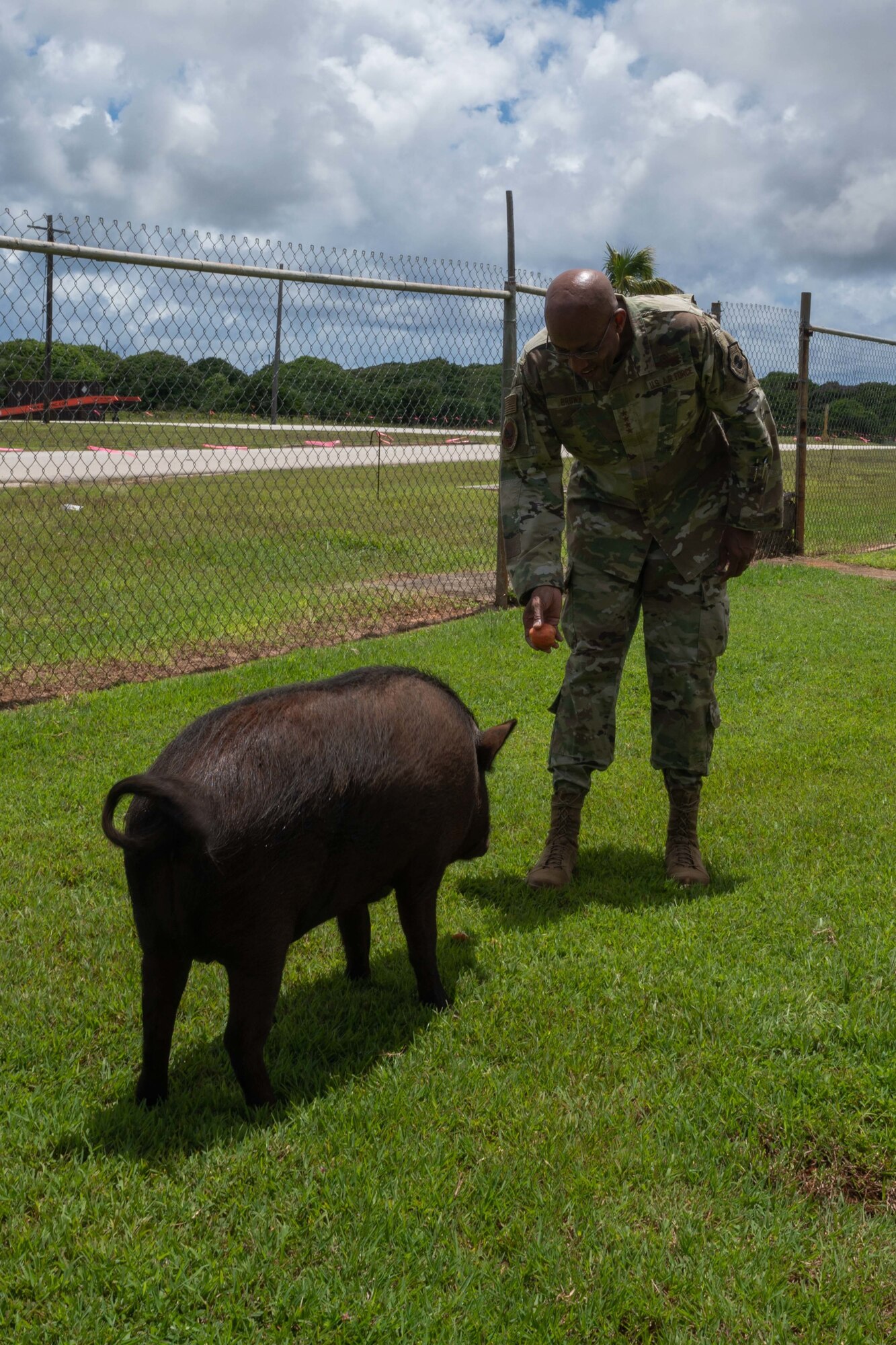 U.S. Air Force Chief of Staff Gen. CQ Brown, Jr. meets Shakey the pig, 36th Munitions Squadron mascot, at Andersen Air Force Base, Guam, Aug. 7, 2022.