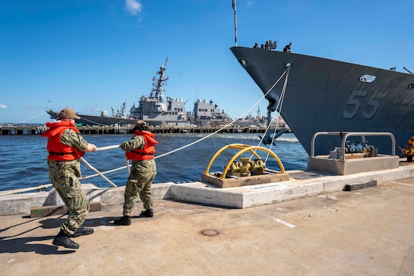 Line handlers cast off mooring lines from the pier as the Ticonderoga-class guided-missile cruiser USS Leyte Gulf (CG 55) gets underway aboard Naval Station Norfolk.