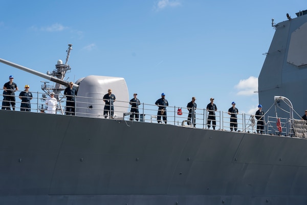 Sailors man the rails as the Ticonderoga-class guided-missile cruiser USS Leyte Gulf (CG 55) departs Naval Station Norfolk.