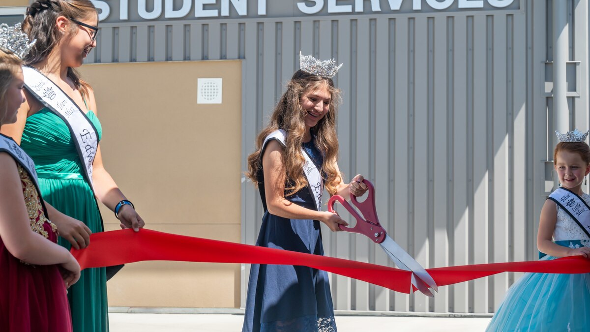 Junior Miss Edwards Hailey Shartzer cuts the ribbon to officially open the new Desert Jr./Sr. High School on Edwards Air Force Base, California, Aug. 9. (Air Force photo by Giancarlo Casem)