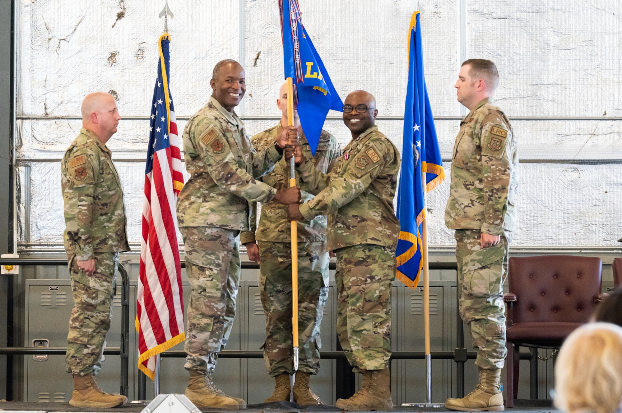 Maj. George Okorodudu, center right, outgoing 436th Logistics Readiness Squadron commander, passes the guidon to Col. Phelemon Williams, 436th Mission Support Group commander, during a change of command ceremony at Dover Air Force Base, Delaware, June 6, 2022. The ceremony saw Okorodudu relinquish command of the 436th LRS to Maj. James Greenwood and the squadron was redesignated under the newly activated 436th Mission Generation Group. (U.S. Air Force photo by Mauricio Campino)