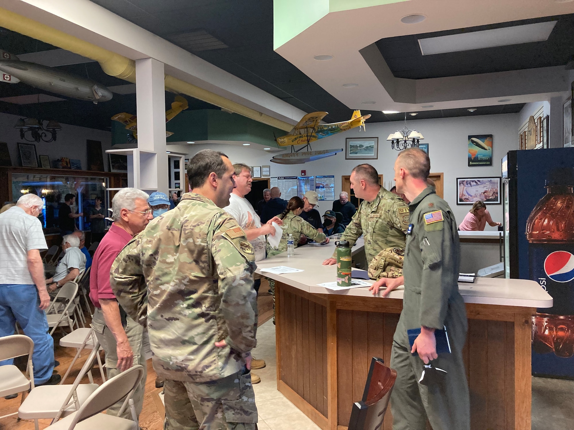 U.S. Air Force Airmen assigned to the 305th Air Mobility Wing discuss the Mid-Air Collision Avoidance program with civilian pilots.