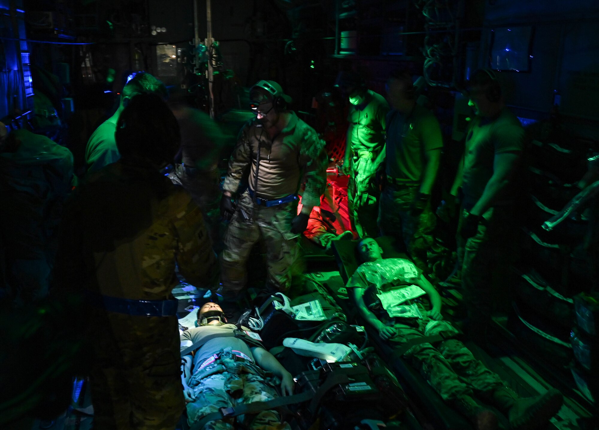Medical staff from the 379th Expeditionary Air Evacuation Squadron and 379th Expeditionary Medical Group tend to patients on board an MC-130J Commando during an exercise Aug 4, 2022 at Al Udeid Airbase, Qatar. The Airmen operated in low light conditions to maintain their readiness. (U.S. Air National Guard photo by Master Sgt. Michael J. Kelly)