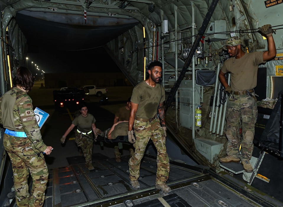Airmen from the 379th Expeditionary Air Evacuation Squadron transport patients on board an MC-130J Commando II during an exercise Aug 4, 2022 at Al Udeid Airbase, Qatar. Casualties stowed away receive swift medical attention from flight nurses. (U.S. Air National Guard photo by Master Sgt. Michael J. Kelly)