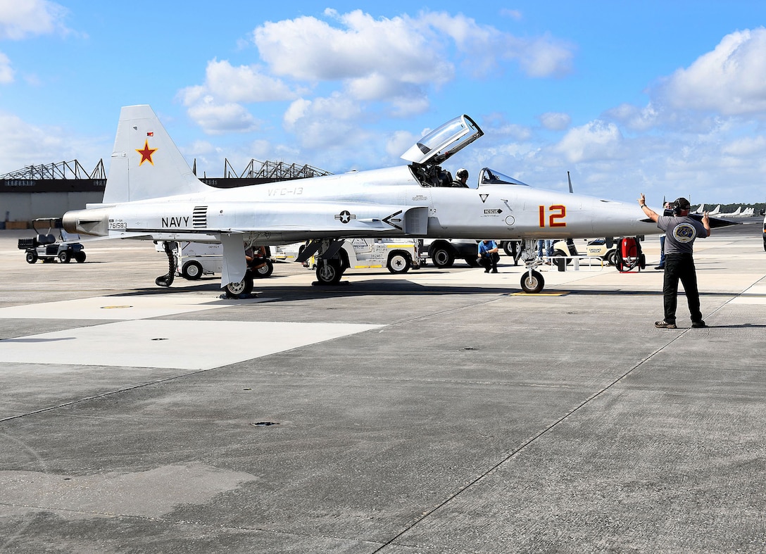 JACKSONVILLE, Fla. (March 1, 2021) Joe Hawley, a Fleet Readiness Center Southeast (FRCSE) ground check plane captain, completes flight control checks with FRCSE Adversary Production Officer, Cdr. Mitchell Conover, in support of a functional check flight (FCF). An FCF tests the aircraft and all of its systems to ensure they work properly. (U.S. Navy Photo by Toiete Jackson/Released)