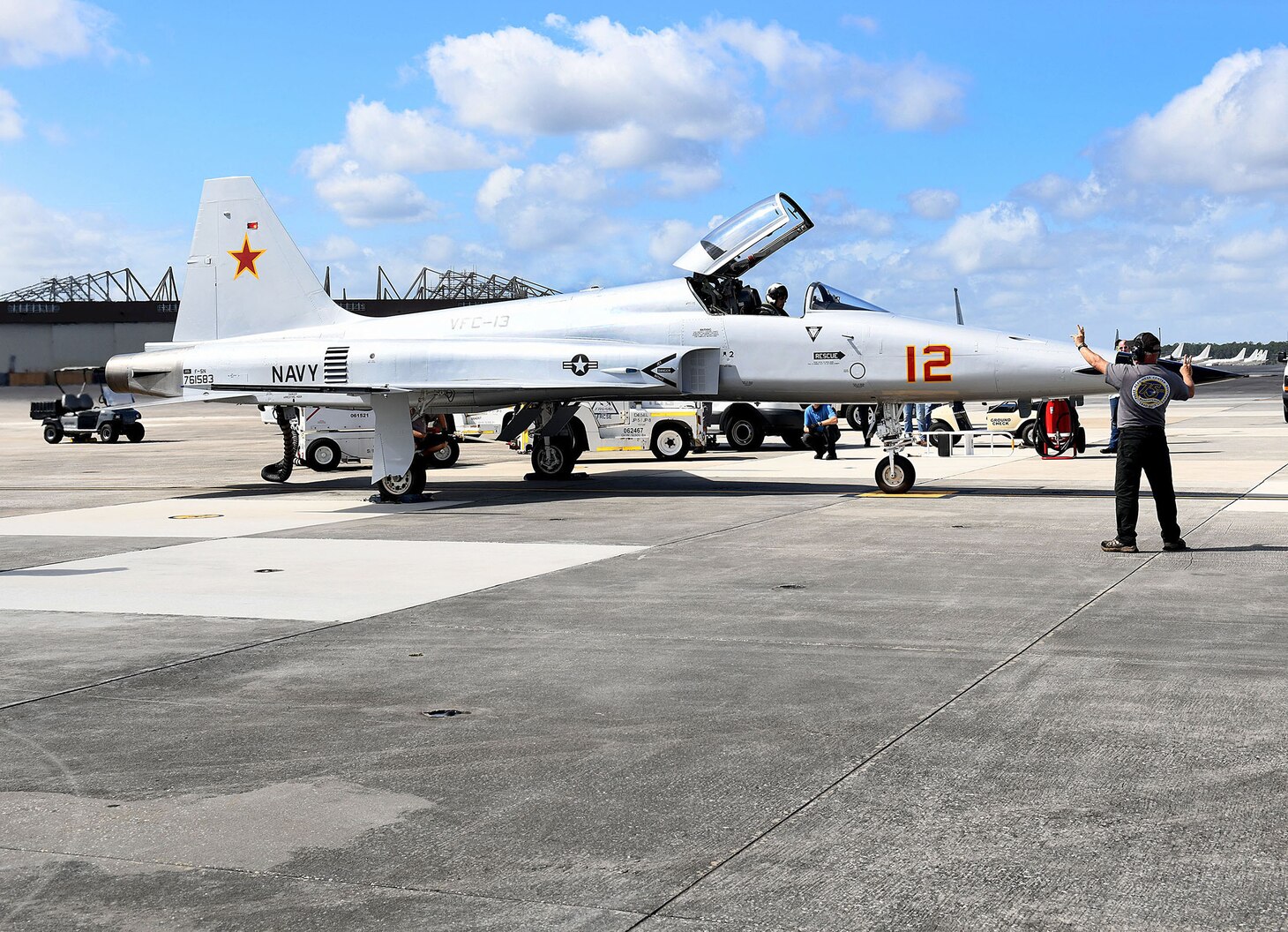 JACKSONVILLE, Fla. (March 1, 2021) Joe Hawley, a Fleet Readiness Center Southeast (FRCSE) ground check plane captain, completes flight control checks with FRCSE Adversary Production Officer, Cdr. Mitchell Conover, in support of a functional check flight (FCF). An FCF tests the aircraft and all of its systems to ensure they work properly. (U.S. Navy Photo by Toiete Jackson/Released)