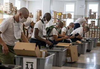 220702-N-PW480-0233 GREAT LAKES, Ill. (July 2, 2022) Naval Reserve Officers Training Corps (NROTC) New Student Indoctrination (NSI) 2022 Cycle 2 midshipman candidates lace their boots during uniform issue at Recruit Training Command (RTC), July 2. Upon completion of NSI, the candidates will start their freshman year of the NROTC program at colleges and universities nationwide this fall. NSI is an indoctrination program hosted at RTC, and provides midshipmen with a common military training orientation. NSI provides basic training in five warfighting fundamentals – firefighting, damage control, seamanship, watchstanding and small arms handling and marksmanship – to begin creating basically trained and smartly disciplined future Navy and Marine Corps officers. NROTC is overseen by Commander, Naval Service Training Command (NSTC), Rear Adm. Jennifer S. Couture, which supports naval accessions training for 98 percent of the Navy’s new officers and enlisted Sailors. (U.S. Navy photo by Mass Communication Specialist 2nd Class Nikita Custer)