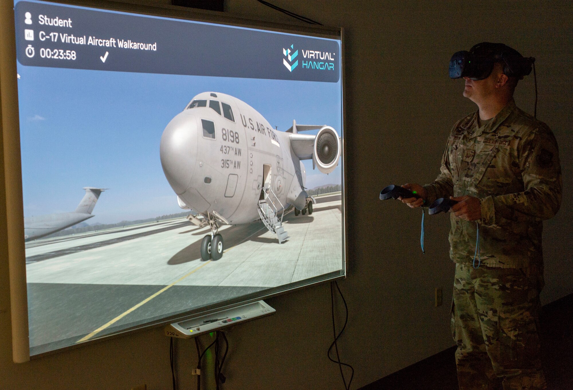 Staff Sgt. James Hart, 436th Aerial Port Squadron fleet services supervisor, walks around a C-17 Globemaster III using virtual reality goggles during a multi-capable Airmen training class at Dover Air Force Base, Delaware, March 29, 2022. Hart and other MCA students used VR goggles to familiarize themselves with C-17 and C-5M Super Galaxy aircraft by performing a virtual walkaround. (U.S. Air Force photo by Roland Balik)