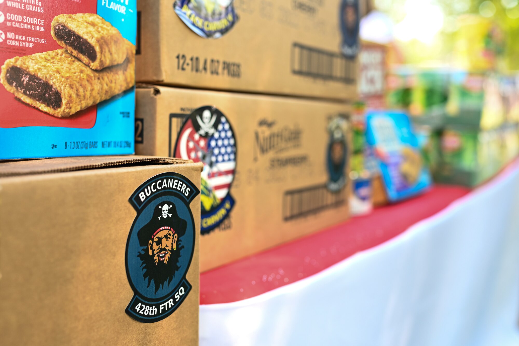 Squadron morale stickers ornament boxes of food donated by the 428th Fighter Squadron from the Republic of Singapore.