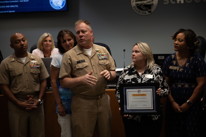 PANAMA CITY, FL- The Naval Support Activity Panama City command team, Cmdr. Keith Foster and CMDCS Duriel Crittenden joined the NSA Panama City's School Liason Officer, Erin Pickard on August 09, to celebrate NSA Panama City, Tyndall Air Force Base, Bay District Schools, and local Charter Schools (Bay Area Education Alliance) winning the “2022 (LTG) Pete Taylor Partnership of Excellence Award.”