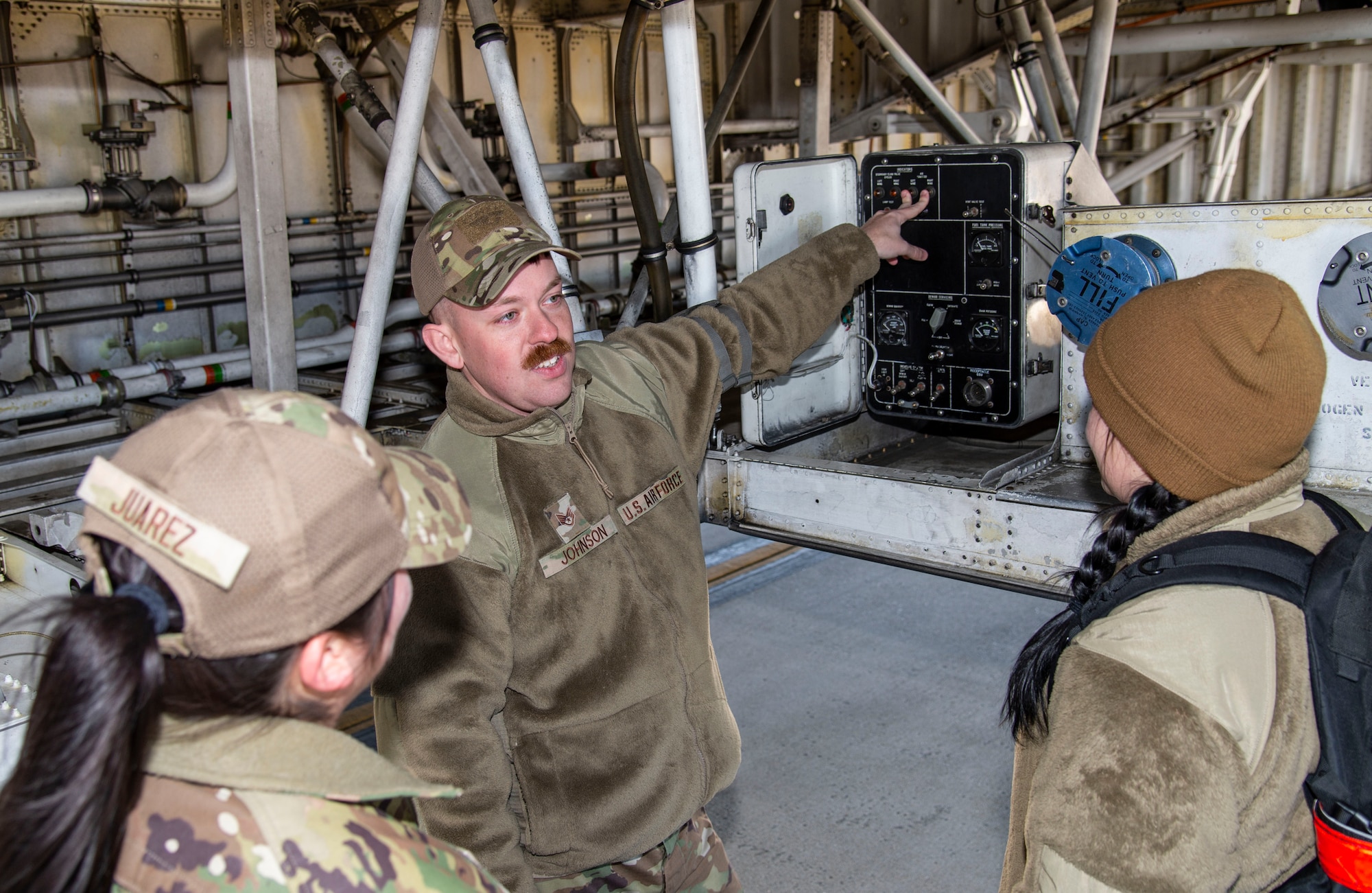 Staff Sgt. Zachary Johnson, 373rd Training Squadron, Detachment 3 C-5 aircraft general instructor, familiarizes students with the C-5M Super Galaxy liquid nitrogen servicing panel at Dover Air Force Base, Delaware, March 29, 2022. Johnson provided students participating in a multi-capable Airmen training class with basic C-5 aircraft familiarization. (U.S. Air Force photo by Roland Balik)