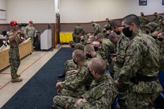220713-N-ZW825-0024 GREAT LAKES, Ill. (July 13, 2022) Naval Reserve Officers Training Corps (NROTC) New Student Indoctrination (NSI) midshipman candidates receive instruction prior to a small arms live fire training event at Recruit Training Command (RTC), July 13. Upon completion of NSI, the candidates will start their freshman year of the NROTC program at colleges and universities nationwide this fall. NSI is an indoctrination program hosted at RTC, and provides midshipmen with a common military training orientation. NSI provides basic training in five warfighting fundamentals – firefighting, damage control, seamanship, watchstanding and small arms handling and marksmanship – to begin creating basically trained and smartly disciplined future Navy and Marine Corps officers. NROTC is overseen by Commander, Naval Service Training Command (NSTC), Rear Adm. Jennifer S. Couture, which supports naval accessions training for 98 percent of the Navy’s new officers and enlisted Sailors. (U.S. Navy photo by Chief Mass Communication Specialist Byron C. Linder)