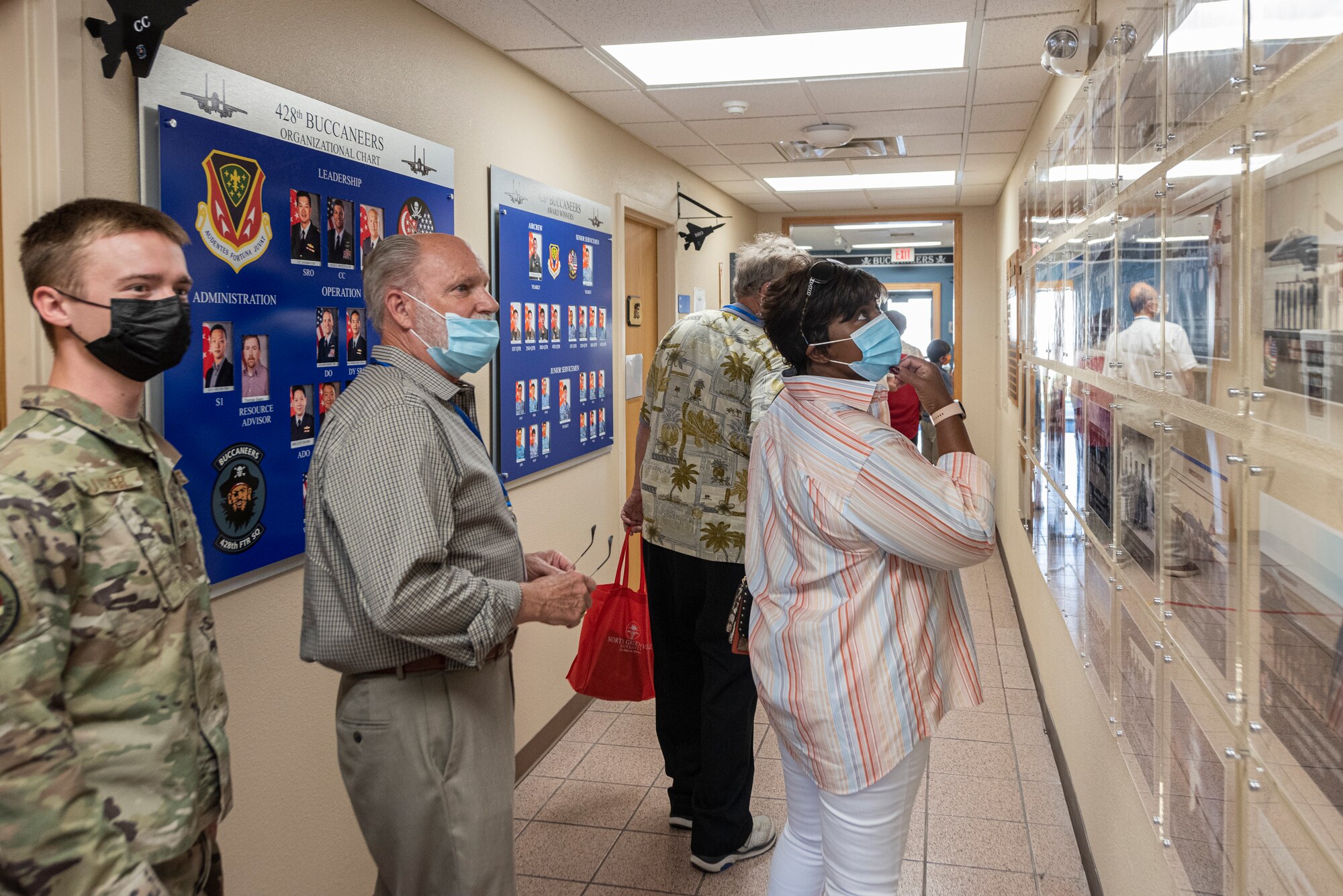 Faith leaders of the community walk around the 428th Flying Squadron building during the tour.
