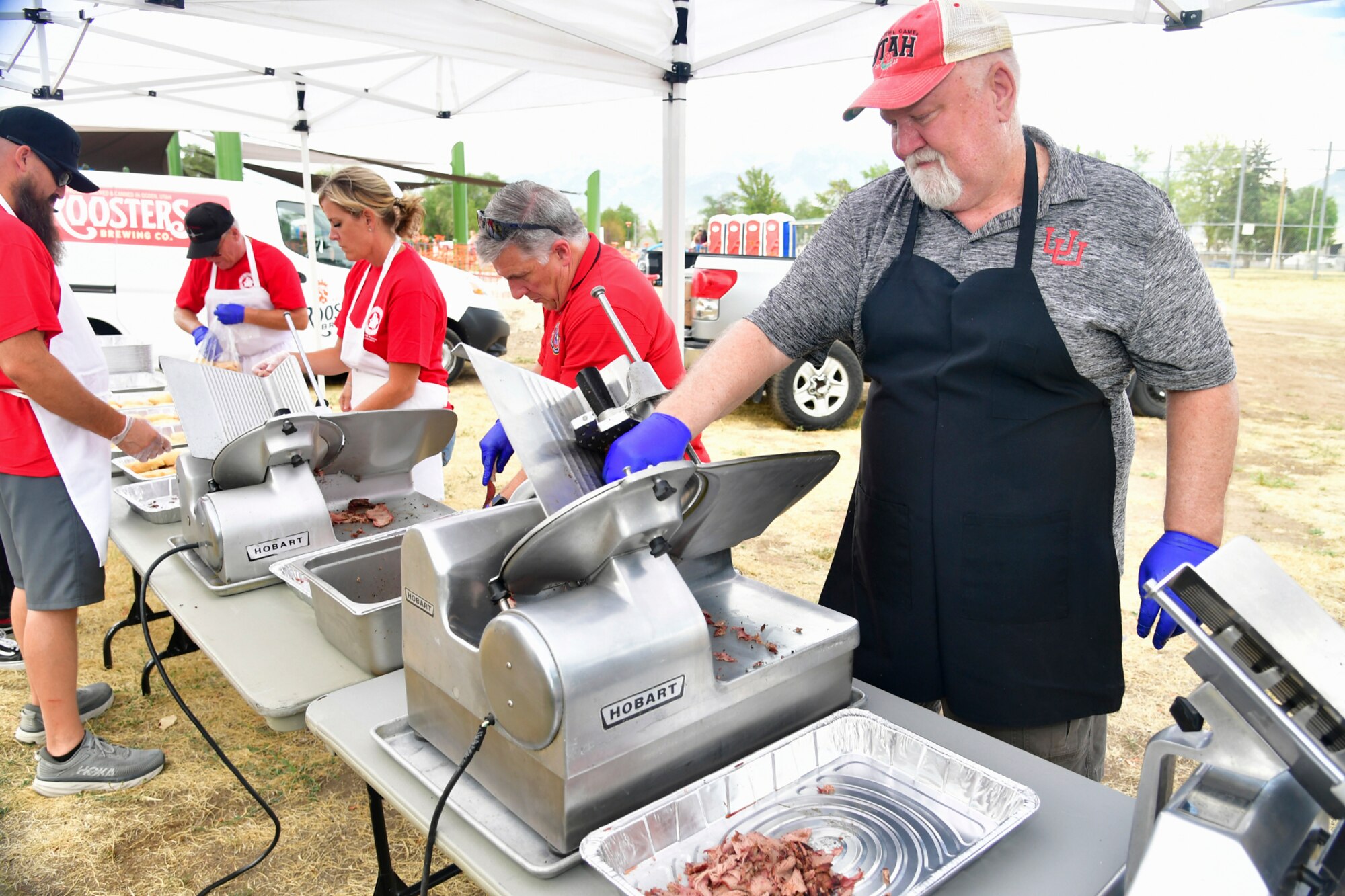 Lane Robinson, Holy Smoke BBQ & Grill volunteer, slices meat during the Military Salute Picnic held at Centennial Park Aug. 5, 2022, at Hill Air Force Base, Utah. The annual event is sponsored by the Top of Utah Military Affairs Committee and provided fun activities, free food and live entertainment for the base’s military and their families. (U.S. Air Force photo by Todd Cromar)