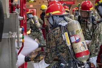 220715-N-ZW825-0722 GREAT LAKES, Ill. (July 15, 2022) Naval Reserve Officers Training Corps (NRTOC) New Student Indoctrination (NSI) midshipman candidates fight a class Alpha fire during firefighting application training at Recruit Training Command (RTC), July 15. Upon completion of NSI, the candidates will start their freshman year of the NROTC program at colleges and universities nationwide this fall. NSI is an indoctrination program hosted at RTC, and provides midshipmen with a common military training orientation. NSI provides basic training in five warfighting fundamentals – firefighting, damage control, seamanship, watchstanding and small arms handling and marksmanship – to begin creating basically trained and smartly disciplined future Navy and Marine Corps officers. NROTC is overseen by Commander, Naval Service Training Command (NSTC), Rear Adm. Jennifer S. Couture, which supports naval accessions training for 98 percent of the Navy’s new officers and enlisted Sailors. (U.S. Navy photo by Chief Mass Communication Specialist Byron C. Linder)