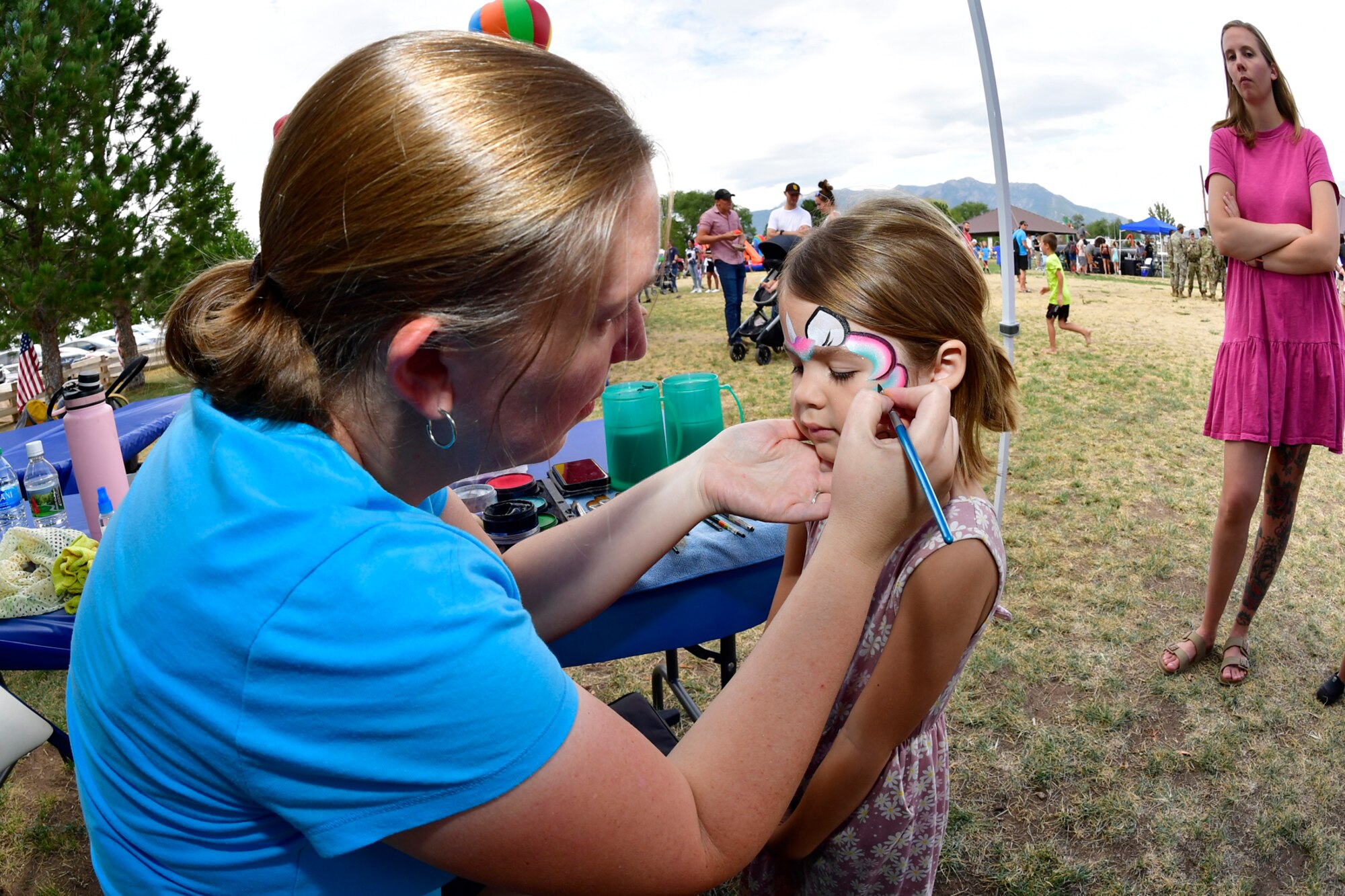 Lylia Shorts (right), gets her face painted by Cindy Phills, Changing Faces, during the Military Salute Picnic held at Centennial Park Aug. 5, 2022, at Hill Air Force Base, Utah. The annual event is sponsored by the Top of Utah Military Affairs Committee and provided fun activities, free food and live entertainment for the base’s military and their families. (U.S. Air Force photo by Todd Cromar)