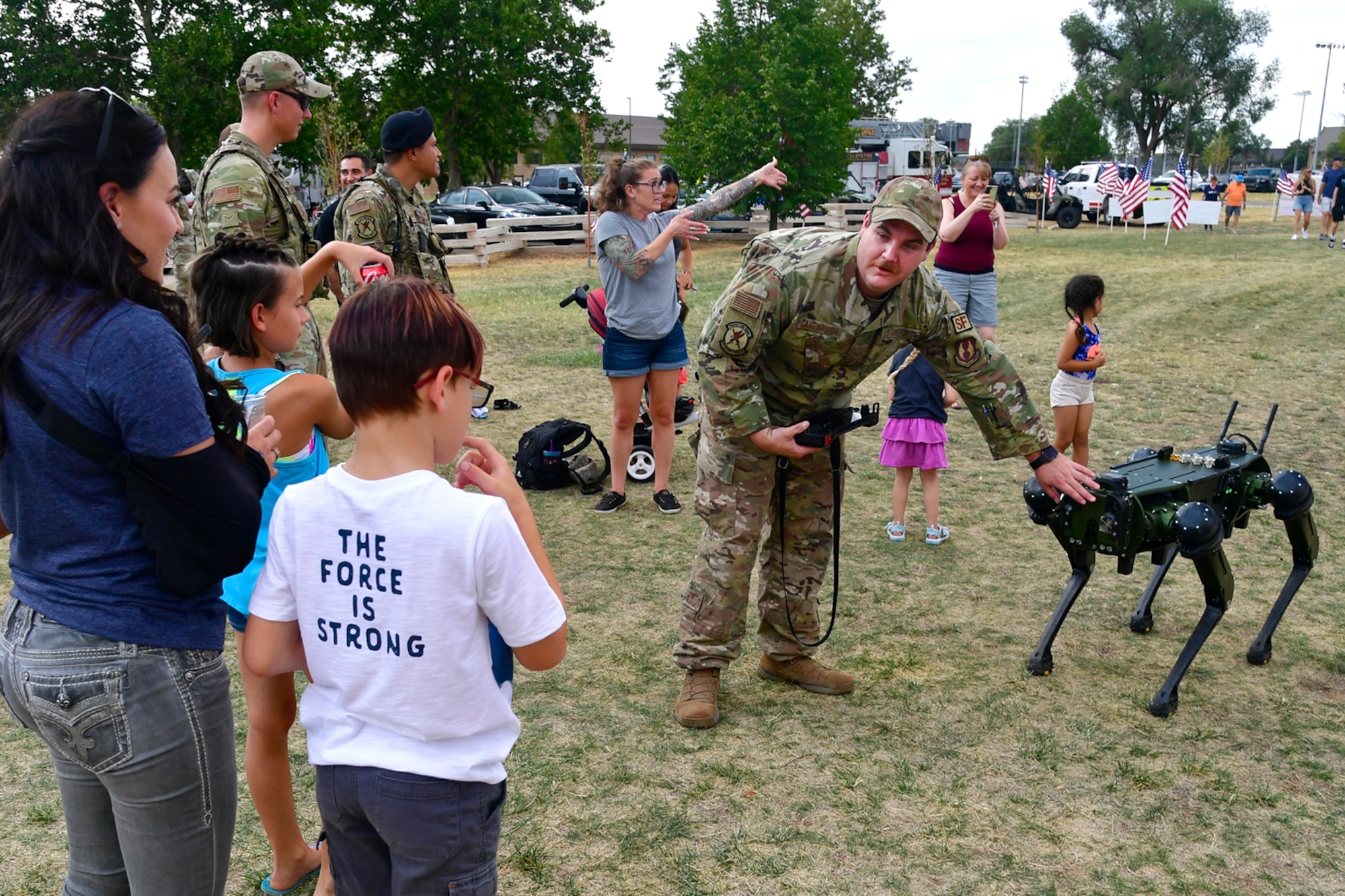 Staff Sgt. Austin Cavenaugh, 75th Security Forces Squadron, demonstrates a robotic dog for visitors during the Military Salute Picnic held at Centennial Park Aug. 5, 2022, at Hill Air Force Base, Utah. The annual event is sponsored by the Top of Utah Military Affairs Committee and provided fun activities, free food and live entertainment for the base’s military and their families. (U.S. Air Force photo by Todd Cromar)