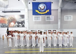 GREAT LAKES, Ill. (July 18, 2022) – Naval Reserve Officers Training Corps (NROTC) New Student Indoctrination (NSI) Cycle 2 midshipman candidates recite their midshipman oath during a graduation ceremony in the Midway Ceremonial Drill Hall at Recruit Training Command (RTC), July 18. The new midshipmen were given their oath by the Commander, Naval Service Training Command (NSTC), Rear Adm. Jennifer S. Couture (on the video screen in the background). Upon completion of NSI, the candidates will start their freshman year of the NROTC program at colleges and universities nationwide this fall. NSI is an indoctrination program hosted at RTC, and provides midshipmen with a common military training orientation. NSI provides basic training in five warfighting fundamentals – firefighting, damage control, seamanship, watchstanding and small arms handling and marksmanship – to begin creating basically trained and smartly disciplined future Navy and Marine Corps officers. NROTC is overseen by Couture and her NSTC staff, headquartered at Naval Station Great Lakes, Illinois, which supports naval accessions training for 98 percent of the Navy’s new officers and enlisted Sailors. (U.S. Navy photo by Scott A. Thornbloom)
