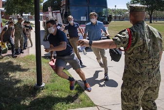 220722-N-ZW825-0110 GREAT LAKES, Ill. (July 22, 2022) Naval Reserve Officers Training Corps (NROTC) New Student Indoctrination (NSI) Cycle 3 midshipman candidates exit the bus upon arrival at Recruit Training Command (RTC), July 22. Upon completion of NSI, the candidates will start their freshman year of the NROTC program at colleges and universities nationwide this fall. NSI is an indoctrination program hosted at RTC, and provides midshipmen with a common military training orientation. NSI provides basic training in five warfighting fundamentals – firefighting, damage control, seamanship, watchstanding and small arms handling and marksmanship – to begin creating basically trained and smartly disciplined future Navy and Marine Corps officers. NROTC is overseen by Commander, Naval Service Training Command (NSTC), Rear Adm. Jennifer S. Couture, which supports naval accessions training for 98 percent of the Navy’s new officers and enlisted Sailors. (U.S. Navy photo by Chief Mass Communication Specialist Byron C. Linder)