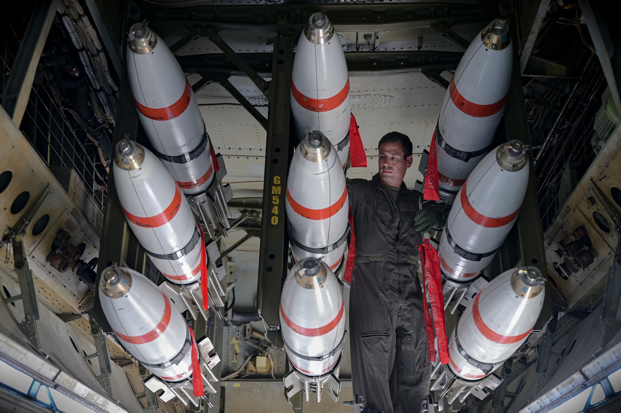 Capt. Jonathan Acker, 20th Bomb Squadron navigator, inspects a MK-62 Naval Quickstrike Mine under a B-52H Stratofortress in support of RIMPAC 2022 at Barksdale Air Force Base, Aug. 1, 2022. Twenty-six nations, 38 ships, three submarines, more than 170 aircraft and 25,000 personnel are participating in RIMPAC from June 29 to Aug. 4 in and around the Hawaiian Islands and Southern California. The world’s largest international maritime exercise, RIMPAC provides a unique training opportunity while fostering and sustaining cooperative relationships among participants critical to ensuring the safety of sea lanes and security on the world’s oceans. RIMPAC 2022 is the 28th exercise in the series that began in 1971. (U.S. Air Force photo by Senior Airman Jonathan E. Ramos)