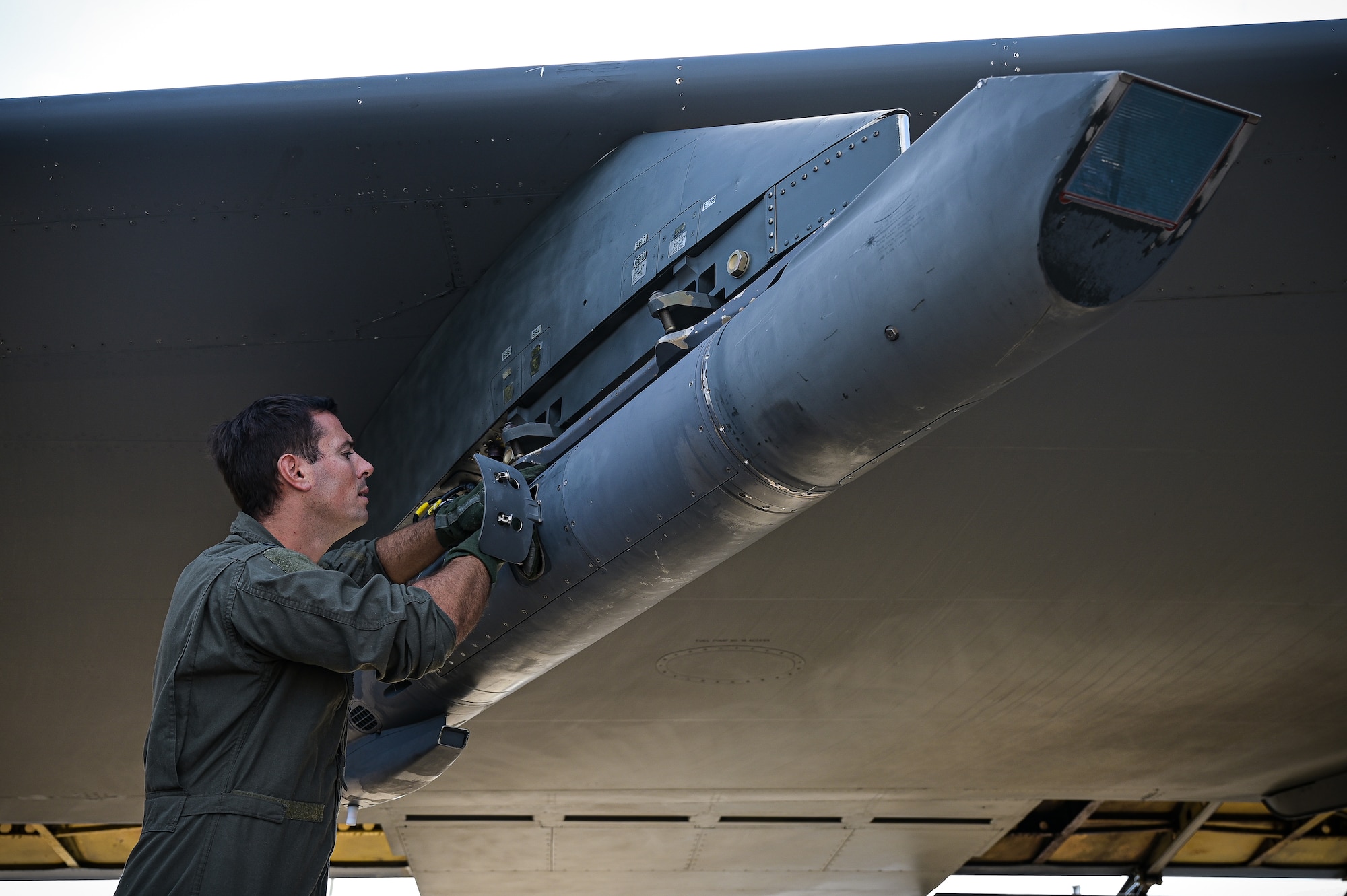 Capt. Jonathan Acker, 20th Bomb Squadron navigator, inspects the sniper pod on a B-52H Stratofortress in support of RIMPAC 2022 at Barksdale Air Force Base, Aug. 1, 2022. Twenty-six nations, 38 ships, three submarines, more than 170 aircraft and 25,000 personnel are participating in RIMPAC from June 29 to Aug. 4 in and around the Hawaiian Islands and Southern California. The world’s largest international maritime exercise, RIMPAC provides a unique training opportunity while fostering and sustaining cooperative relationships among participants critical to ensuring the safety of sea lanes and security on the world’s oceans. RIMPAC 2022 is the 28th exercise in the series that began in 1971. (U.S. Air Force photo by Senior Airman Jonathan E. Ramos)