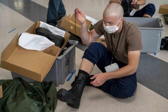 220723-N-PW480-0164 GREAT LAKES, Ill. (July 23, 2022) A Naval Reserve Officers Training Corps (NROTC) New Student Indoctrination (NSI) 2022 Cycle 3 midshipman candidate laces their boots during uniform issue at Recruit Training Command (RTC), July 23. Upon completion of NSI, the candidates will start their freshman year of the NROTC program at colleges and universities nationwide this fall. NSI is an indoctrination program hosted at RTC, and provides midshipmen with a common military training orientation. NSI provides basic training in five warfighting fundamentals – firefighting, damage control, seamanship, watchstanding and small arms handling and marksmanship – to begin creating basically trained and smartly disciplined future Navy and Marine Corps officers. NROTC is overseen by Commander, Naval Service Training Command (NSTC), Rear Adm. Jennifer S. Couture, which supports naval accessions training for 98 percent of the Navy’s new officers and enlisted Sailors. (U.S. Navy photo by Mass Communication Specialist 2nd Class Nikita Custer)